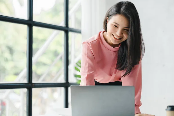 Asian woman working in a startup company, she is working in the office. run by a young, talented woman. The management concept runs the company of female leaders to grow the company.