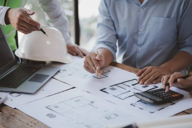 Architects and engineers are working together to edit the draft house plan that was designed after it was presented to the client and partially revised the design. Interior design and decoration ideas