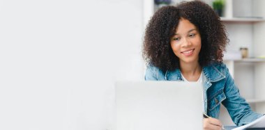 American woman sits in the white office of a startup company, she is a company employee, young generation operations run the company with the concept of the new generation. Company management concept