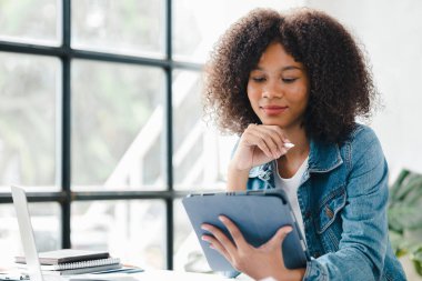 American woman sits in the white office of a startup company, she is a company employee, young generation operations run the company with the concept of the new generation. Company management concept