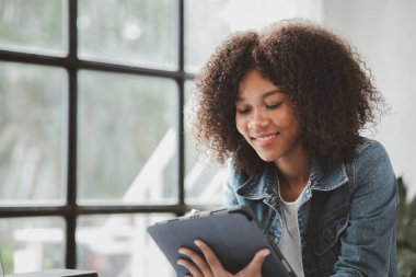 American woman sits in the white office of a startup company, she is a company employee, young generation operations run the company with the concept of the new generation. Company management concept