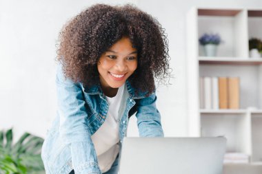 American woman sits in the white office of a startup company, she is a company employee, young generation operations run the company with the concept of the new generation. Company management concept