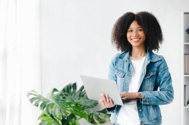 American woman sits in the white office of a startup company, she is a company employee, young generation operations run the company with the concept of the new generation. Company management concept