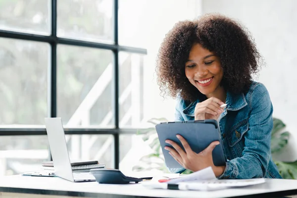 American woman sits in the white office of a startup company, she is a company employee, young generation operations run the company with the concept of the new generation. Company management concept