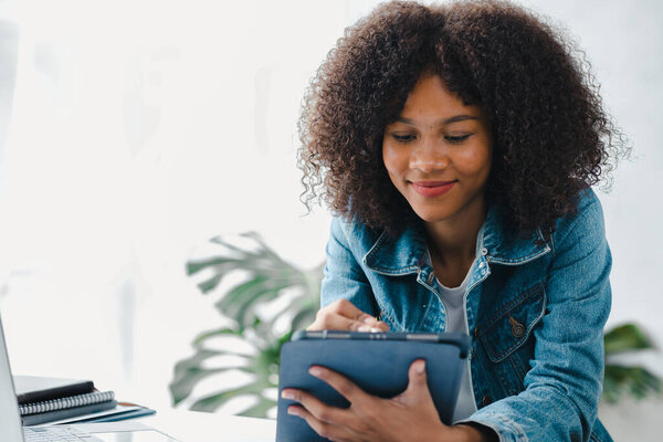 American woman sits in the white office of a startup company, she is a company employee, young generation operations run the company with the concept of the new generation. Company management concept