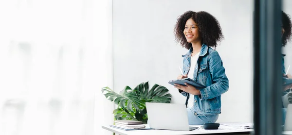 American woman sits in the white office of a startup company, she is a company employee, young generation operations run the company with the concept of the new generation. Company management concept