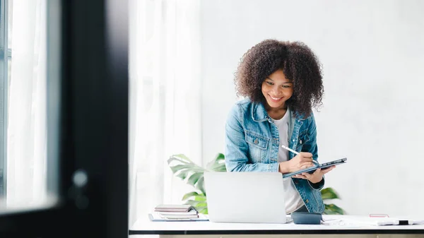 American woman sits in the white office of a startup company, she is a company employee, young generation operations run the company with the concept of the new generation. Company management concept