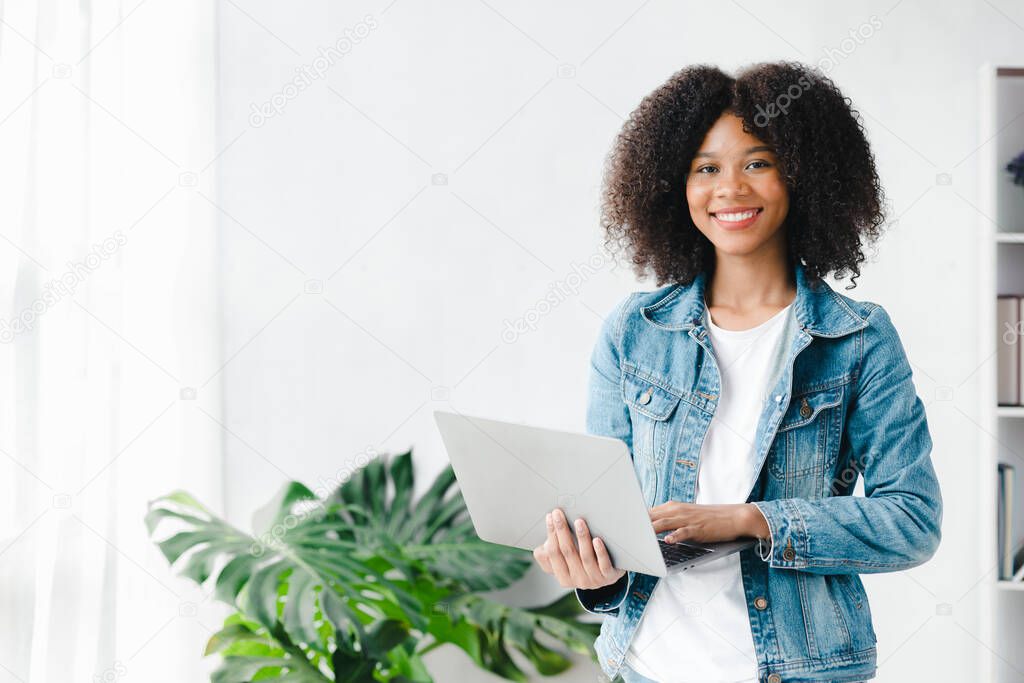 American woman sits in the white office of a startup company, she is a company employee, young generation operations run the company with the concept of the new generation. Company management concept