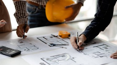 Architects and engineers are working together to edit the draft house plan that was designed after it was presented to the client and partially revised the design. Interior design and decoration ideas