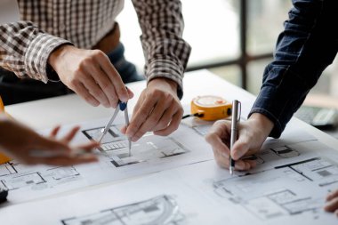 Architects and engineers are working together to edit the draft house plan that was designed after it was presented to the client and partially revised the design. Interior design and decoration ideas