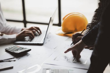 Architects and engineers are working together to edit the draft house plan that was designed after it was presented to the client and partially revised the design. Interior design and decoration ideas