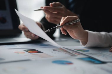The sales department is having a monthly summary meeting to bring it to the department manager, they are verifying the correctness of the documents that are prepared before bringing in to the manager