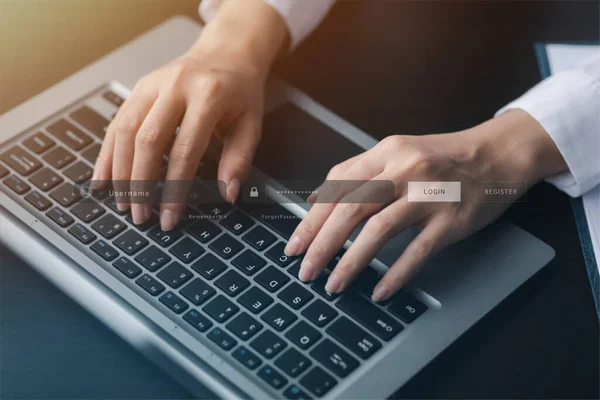 An individual is typing on a keyboard laptop showing a hologram interface to a member login, a businessman is going to access the company\'s membership system, check the information of the parties.