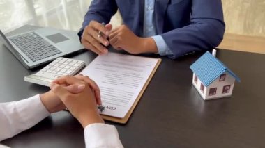 The salesperson of the housing estate in the project is preparing and verifying the contract of sale for the customer who will enter the contract. Concept of selling housing estates and real estate.