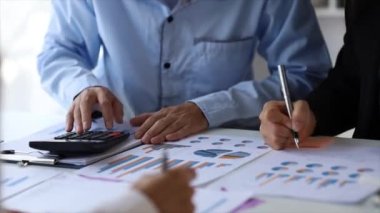 The sales department is having a monthly summary meeting to bring it to the department manager, they are verifying the correctness of the documents that are prepared before bringing in to the manager