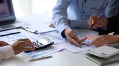 The sales department is having a monthly summary meeting to bring it to the department manager, they are verifying the correctness of the documents that are prepared before bringing in to the manager