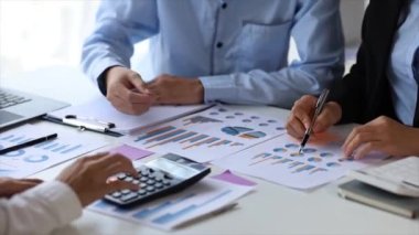 The sales department is having a monthly summary meeting to bring it to the department manager, they are verifying the correctness of the documents that are prepared before bringing in to the manager