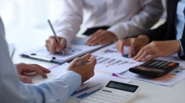 The sales department is having a monthly summary meeting to bring it to the department manager, they are verifying the correctness of the documents that are prepared before bringing in to the manager