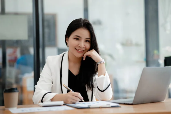 Beautiful Asian woman running a company, businesswoman who founded a new generation of startup companies, management run by female leaders, female bosses. Business administration concept.