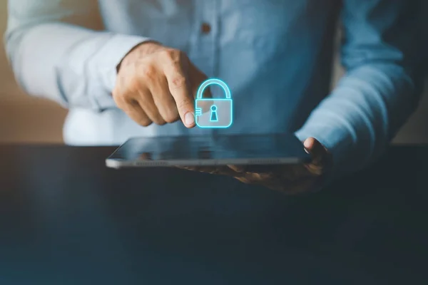 Person pointing at tablet screen with padlock icon, tablet data access lock for data privacy and security, protection and protection against personal data infringement.