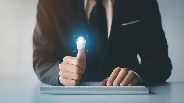 Businessman with a laptop, hologram icon fingerprint encryption, protecting access to confidential information by using fingerprint technology. Fingerprint encryption concept.