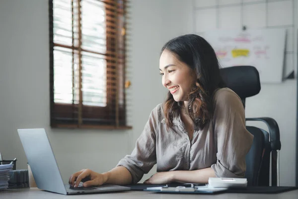 Asian women working in the office, young Asian business women as business executives, founding and running start-up executives, young female business leaders. Startup business concept.