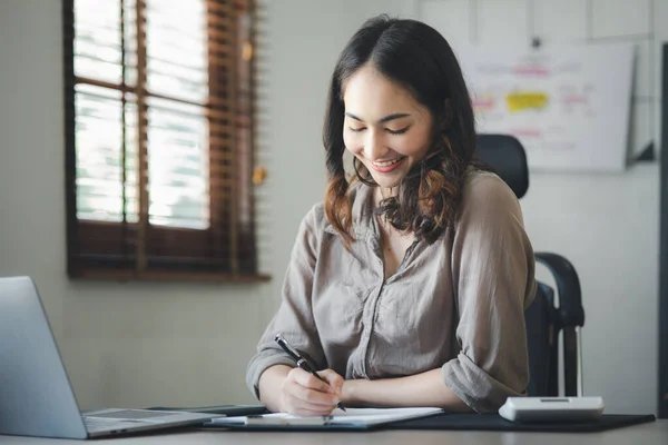 Asian women working in the office, young Asian business women as business executives, founding and running start-up executives, young female business leaders. Startup business concept.