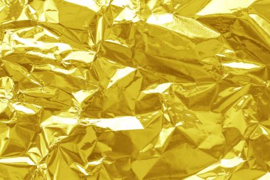 Parlak altın folyo desenli arka plan, buruşuk ve dalgalı sarı ambalaj kağıdı deseni.