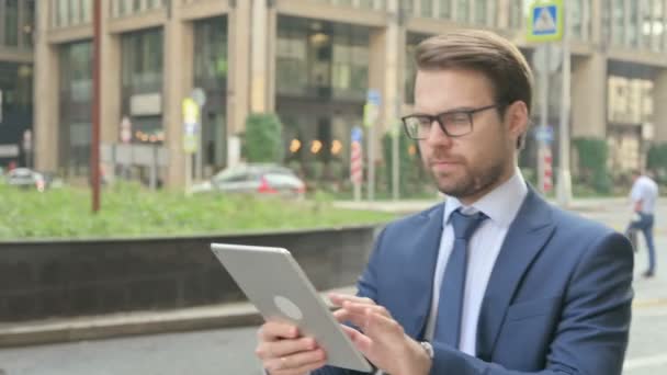Businessman Working on Tablet while Walking in Street — Stock Video