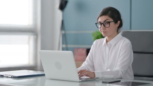 Indische Geschäftsfrau zeigt Daumen-nach-unten-Zeichen, während sie Laptop im Büro benutzt — Stockvideo