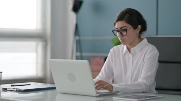 Mujer de negocios india que tiene dolor de muñeca mientras usa el ordenador portátil en la oficina — Vídeos de Stock