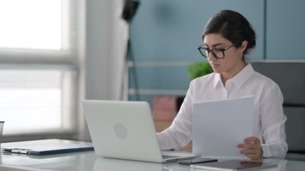 Indian Businesswoman with Laptop Reading Documents in Office — стокове відео