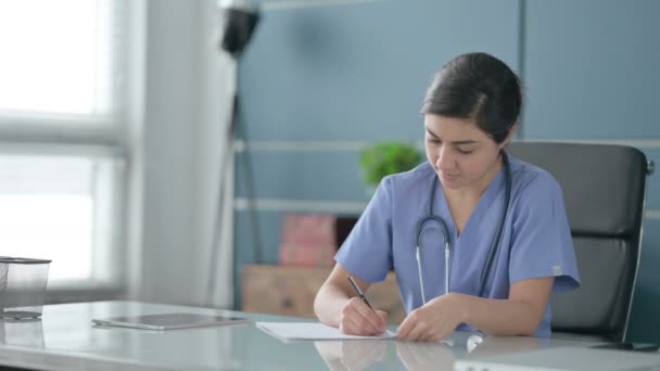 Indian Female Doctor Writing on Paper in Office — Stock Video