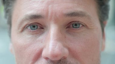 Close up of Blinking Eyes of Middle Aged Businessman clipart