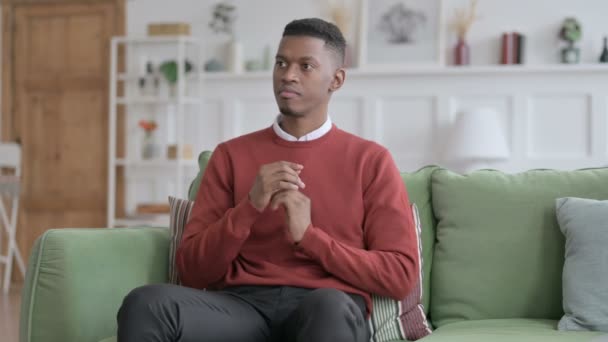 African Man Sitting on Sofa — Stock Video