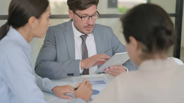 Middle Aged Businessman using Tablet while Preparing Reports with Businesswoman — Stock Photo, Image