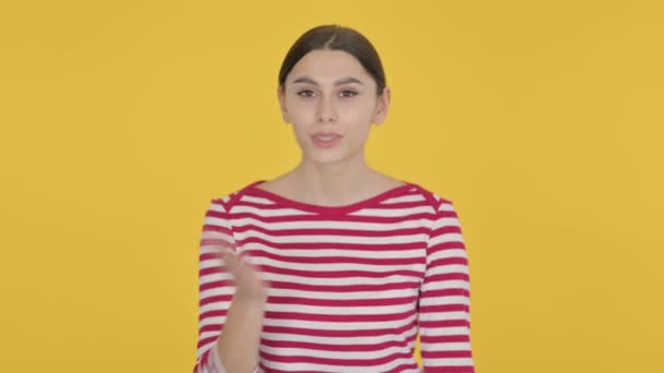 黄色の背景にスペイン人女性によるフライングキス — ストック動画