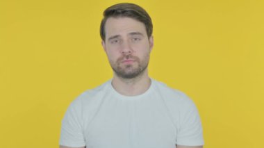 Casual Young Man in Denial on Yellow Background 