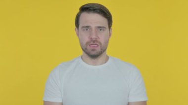 Casual Young Man Shouting and Screaming on Yellow Background 
