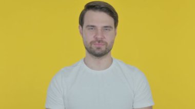 Sıradan Genç Adam Sarı Arkaplanda Kamerayı Gösteriyor 