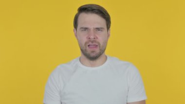 Tired Casual Young Man Yawning on Yellow Background 