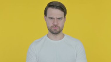 Pensive Casual Young Man Thinking and getting Idea on Yellow Background 