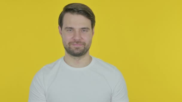 Casual Young Man Showing Side Yellow Background — стоковое видео