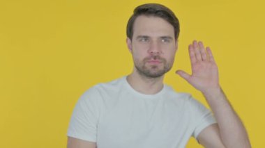 Casual Young Man Trying to Listen Secret, Yellow Screen 