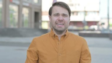 Angry Casual Young Man Shouting and Screaming Outdoor