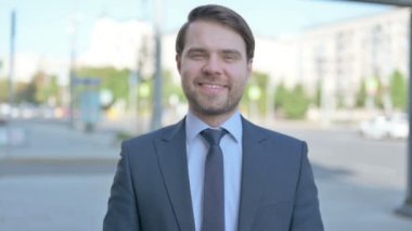 Middle Aged Businessman Pointing at the Camera Outdoor