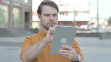 Casual Young Man using Digital Tablet Outdoor