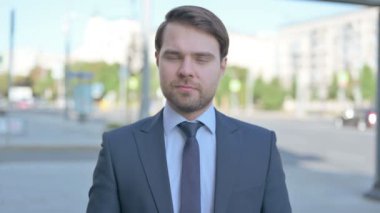Portrait of Disappointed Middle Aged Businessman Reacting to Loss Outdoor