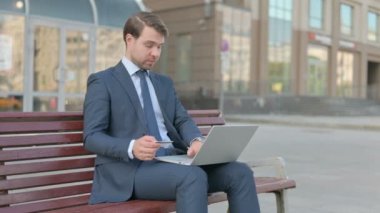 Excited Young Businessman Shopping Online, Sitting Outdoor