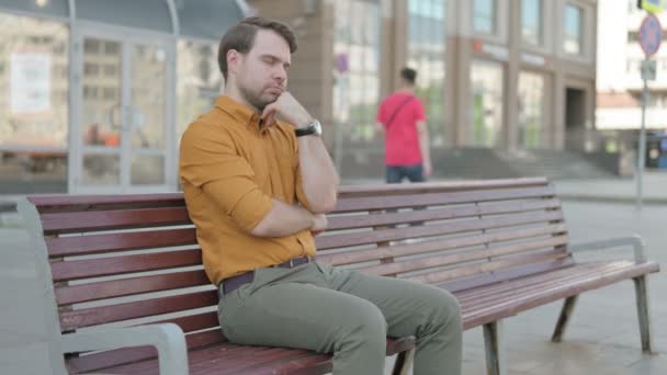 Tired Casual Young Man Sleeping While Sitting Outdoor Bench — Stockvideo